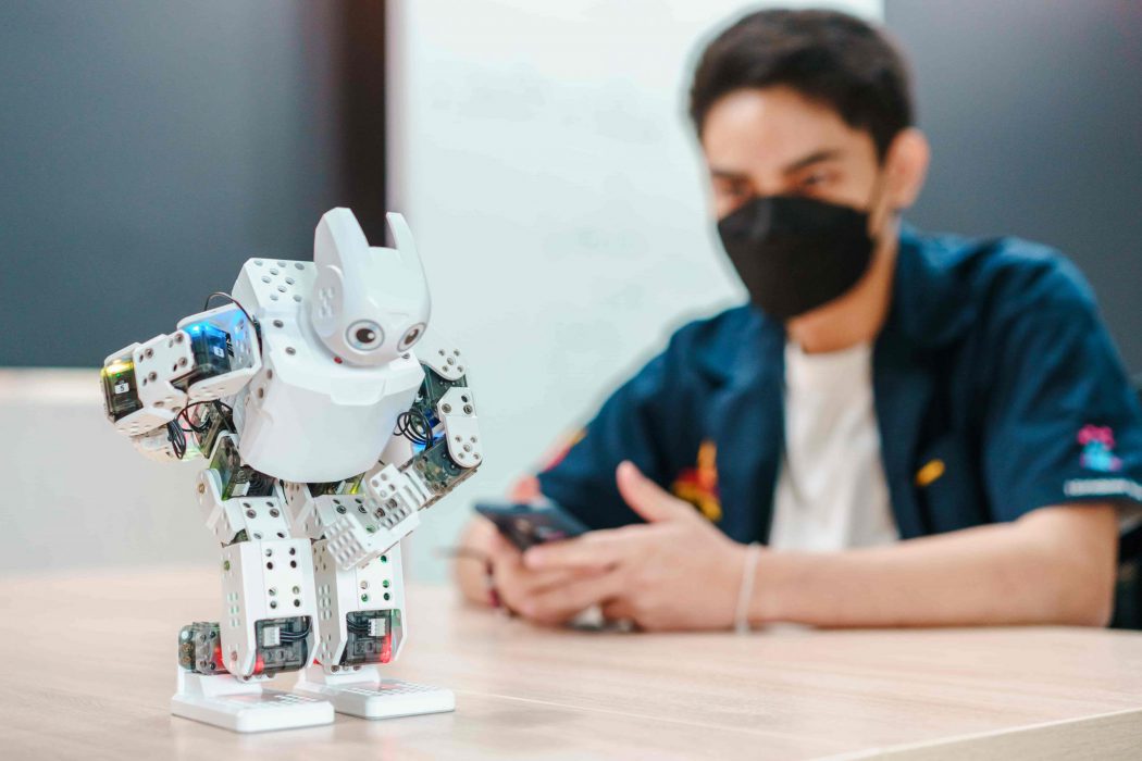 Robotics AI (MATBOT) student is controlling a robot